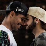 selective focus photography of two smiling men facing each other