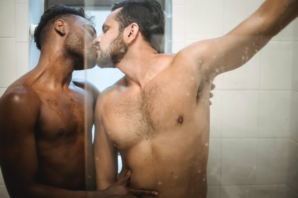 two men kissing in the shower